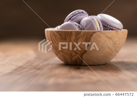 Blueberry macarons in olive wood bowl with copy space 66447572