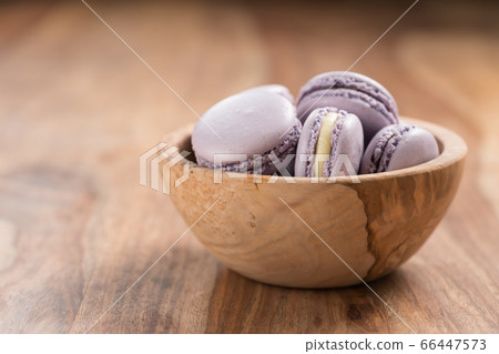 Blueberry macarons in olive wood bowl with copy space Blueberry macarons in olive wood bowl with copy space 66447573
