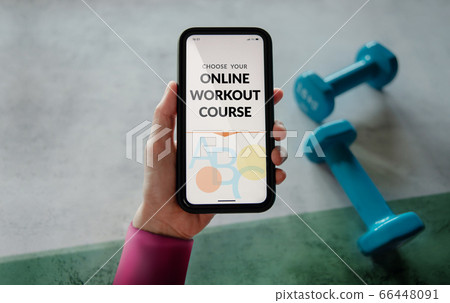 Learning Online Workout Concept. Young Woman using Learning Online Workout Concept. Young Woman using 66448091