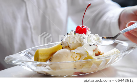 ice cream with whipped cream, banana and cherry 66448612