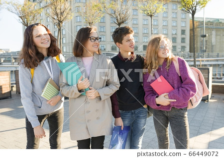 Group of students with teacher, teenagers talking to a female teacher 66449072