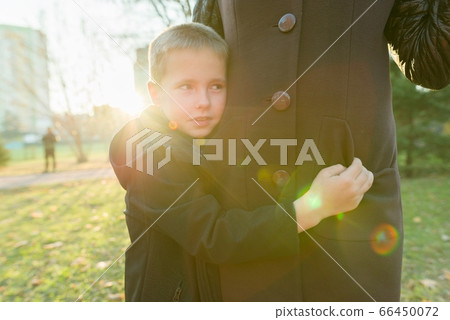 Little son hugging his mother, boy smiling sunny day 66450072
