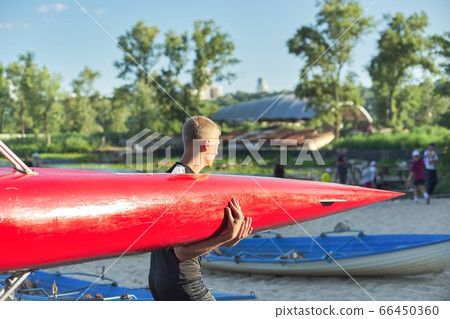 Boy teenager with sports boat kayak, water sports 66450360