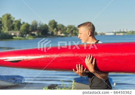 Boy teenager with sports boat kayak, water sports 66450362