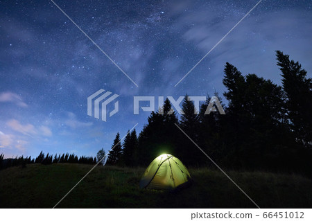 Magical starry night at a campsite in the mountains during summer time Magical starry night at a campsite in the mountains during summer time 66451012
