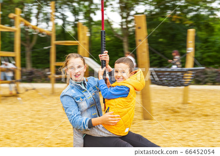 Happy children playing and having fun at playground 66452054