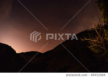 Night star sky background with mountains and trees Night star sky background with mountains and trees 66452884