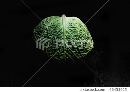 Savoy cabbage on a dark background close-up. Leaf, agriculture. Savoy cabbage on a dark background close-up. Leaf, agriculture. 66453025