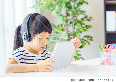 Girl learning online on tablet 66453125