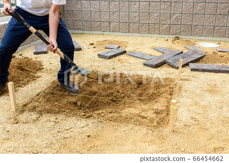 Digging the ground with a shovel to lay sleepers Digging the ground with a shovel to lay sleepers 66454662