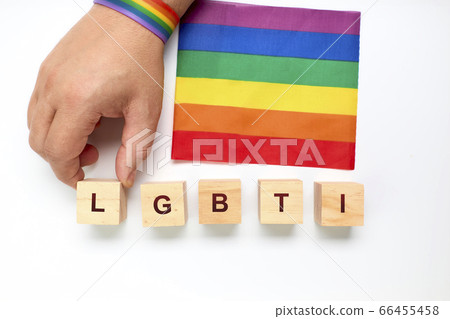 Person with a rainbow bracelet forming with wood Person with a rainbow bracelet forming with wood 66455458