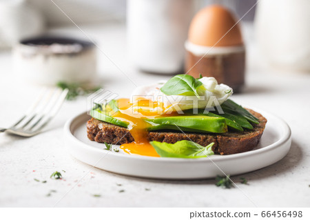 Toasted bread with poached egg 66456498