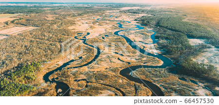 Belarus. Aerial View Of Dry Grass And Curved River Landscape In Early Spring Day. High Attitude View. Marsh Bog. Drone View. Bird's Eye View Belarus. Aerial View Of Dry Grass And Curved River Landscape In Early Spring Day. High Attitude View. Marsh Bog. Drone View. Bird's Eye View 66457530