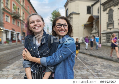 Relationship parent and teenager, hugging smiling mother and daughter 66458502