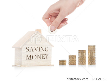 Wooden house model with coins next to it and hand Wooden house model with coins next to it and hand 66459139