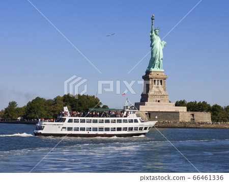 Statue of Liberty ans passenger boat on the foreground, New York City, USA 66461336