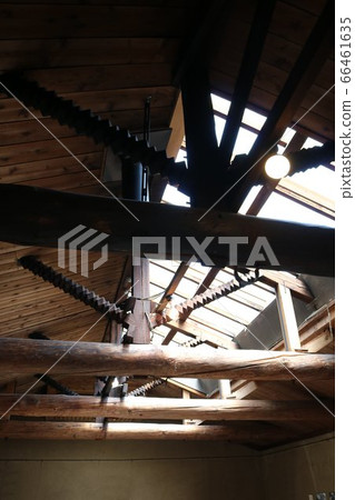 Ceiling space of a house with skylights that let in light and old beams 66461635