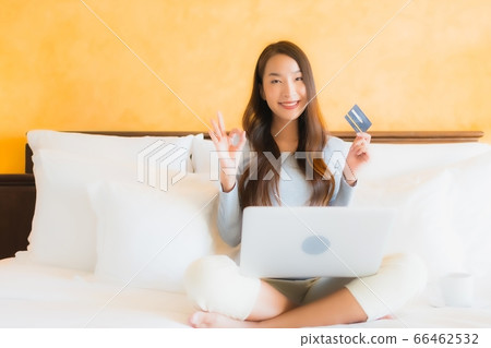 woman work from home with credit card and cardboard box ready for shipping of shopping 66462532