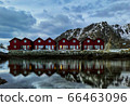 A symmetric row of classic red rorbu in Ballstad, Lofoten island, Norway 66463096