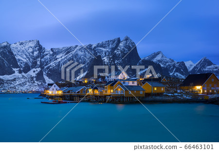 Classic illuminated yellow waterfront rorbu in Reine, Lofoten island, Norway Classic illuminated yellow waterfront rorbu in Reine, Lofoten island, Norway 66463101