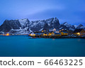Classic illuminated yellow waterfront rorbu in Reine, Lofoten island, Norway 66463225