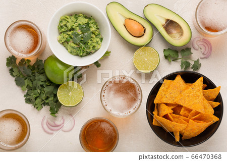 Guacamole, corn chips and beer, light Mexican snack or dinner, , top view 66470368