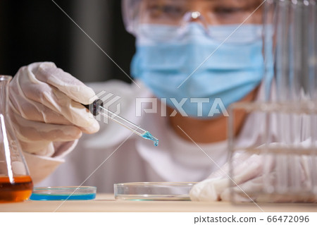 Asian scientist research and analysis chemical test in a laboratory 66472096