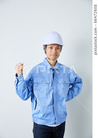 Businessman wearing a helmet and working clothes 66472608