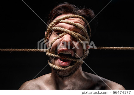 Image of binded man with rope on face 66474177