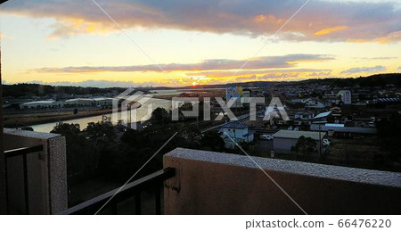 View from the balcony of the sunrise sun, pink and light blue clouds in the sky, meandering rivers, and Spanish village advertisements on buildings View from the balcony of the sunrise sun, pink and light blue clouds in the sky, meandering rivers, and Spanish village advertisements on buildings 66476220