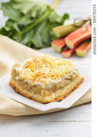 Piece of homemade rhubarb pie on white plate 66476319