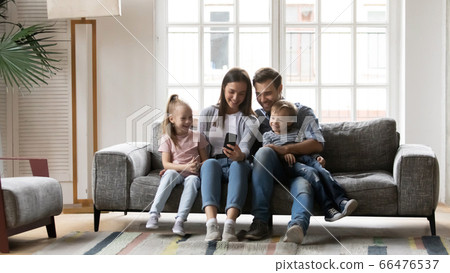 Happy family with children having fun with smartphone 66476537