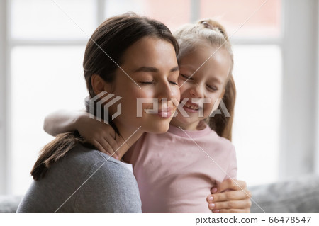 Close up loving young mother hugging adorable little daughter 66478547