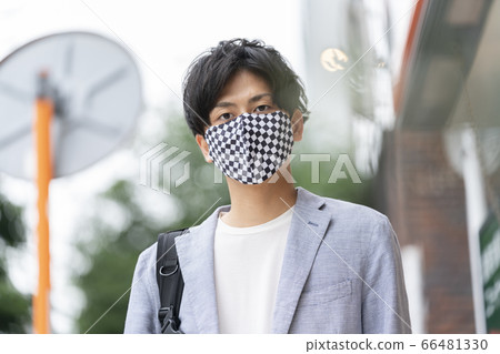 Young man wearing a checkered mask Young man wearing a checkered mask 66481330