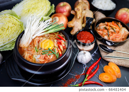 Kimchi cabbage soup in a bowl with materials of the kimchi on black background Kimchi cabbage soup in a bowl with materials of the kimchi on black background 66481404