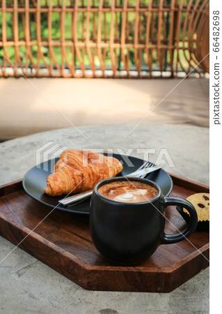 A cup of coffee with latte art on top 66482698