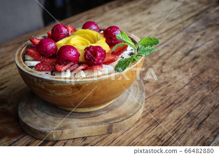 Smoothie bowl decorated with mango, strawberry, 66482880