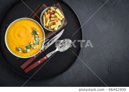 Pumpkin soup with seeds and croutons Pumpkin soup with seeds and croutons 66482909