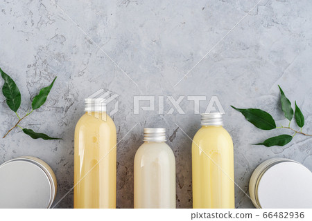 Bottles with spa cosmetic products on grey Bottles with spa cosmetic products on grey 66482936