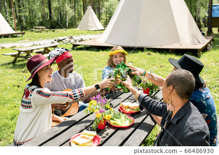 Drinking beer with friends at campsite Drinking beer with friends at campsite 66486930