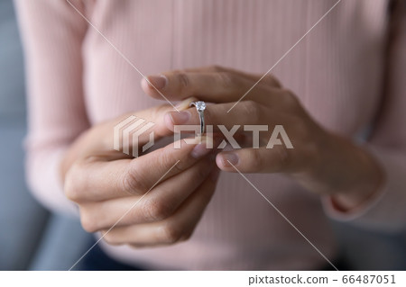 Close up woman taking off wedding ring, divorce concept Close up woman taking off wedding ring, divorce concept 66487051