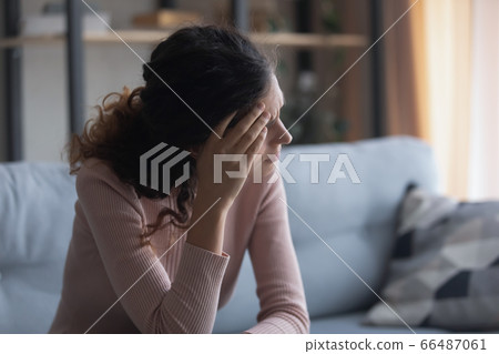 Unhappy depressed woman touching forehead, thinking about problems Unhappy depressed woman touching forehead, thinking about problems 66487061