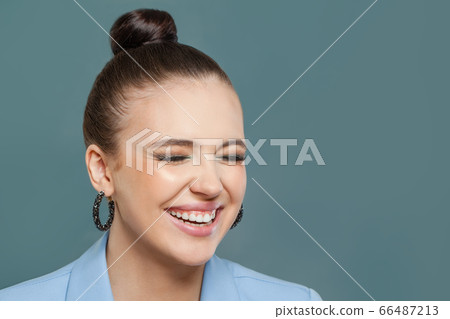Laughing woman on blue background. Perfect face 66487213