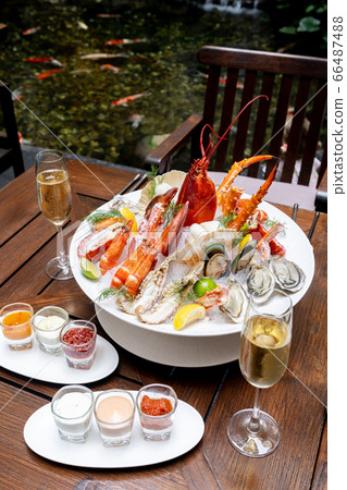 Seafood on ice with white wine Seafood on ice with white wine 66487488