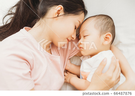 Mother and son sleeping on bed Mother and son sleeping on bed 66487876