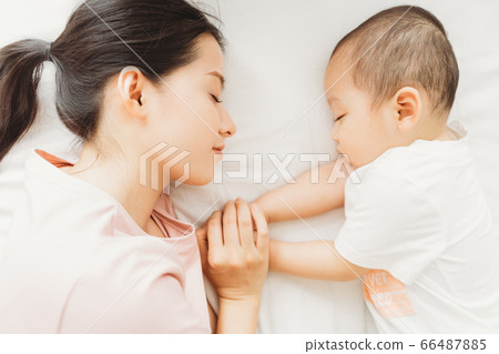 Mother and son sleeping on bed Mother and son sleeping on bed 66487885