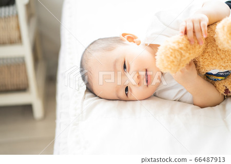 A little boy play on the bed 66487913