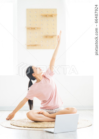 A woman doing yoga at home A woman doing yoga at home 66487924