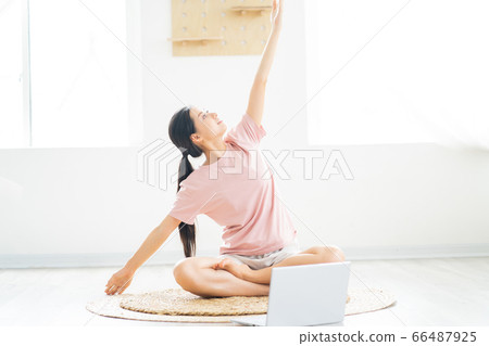 A woman doing yoga at home A woman doing yoga at home 66487925