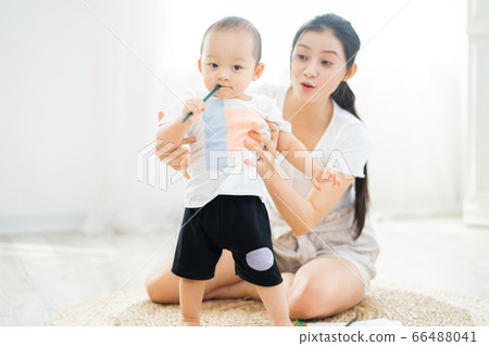 Mother and son playing on the floor Mother and son playing on the floor 66488041